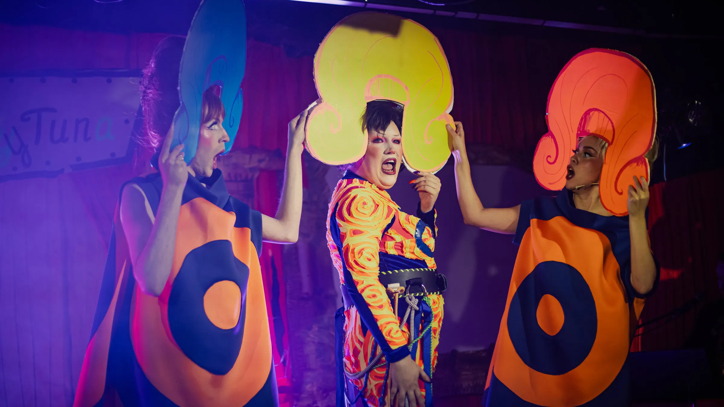 Ms Sharon Le Grand with two dancers in giant wigs