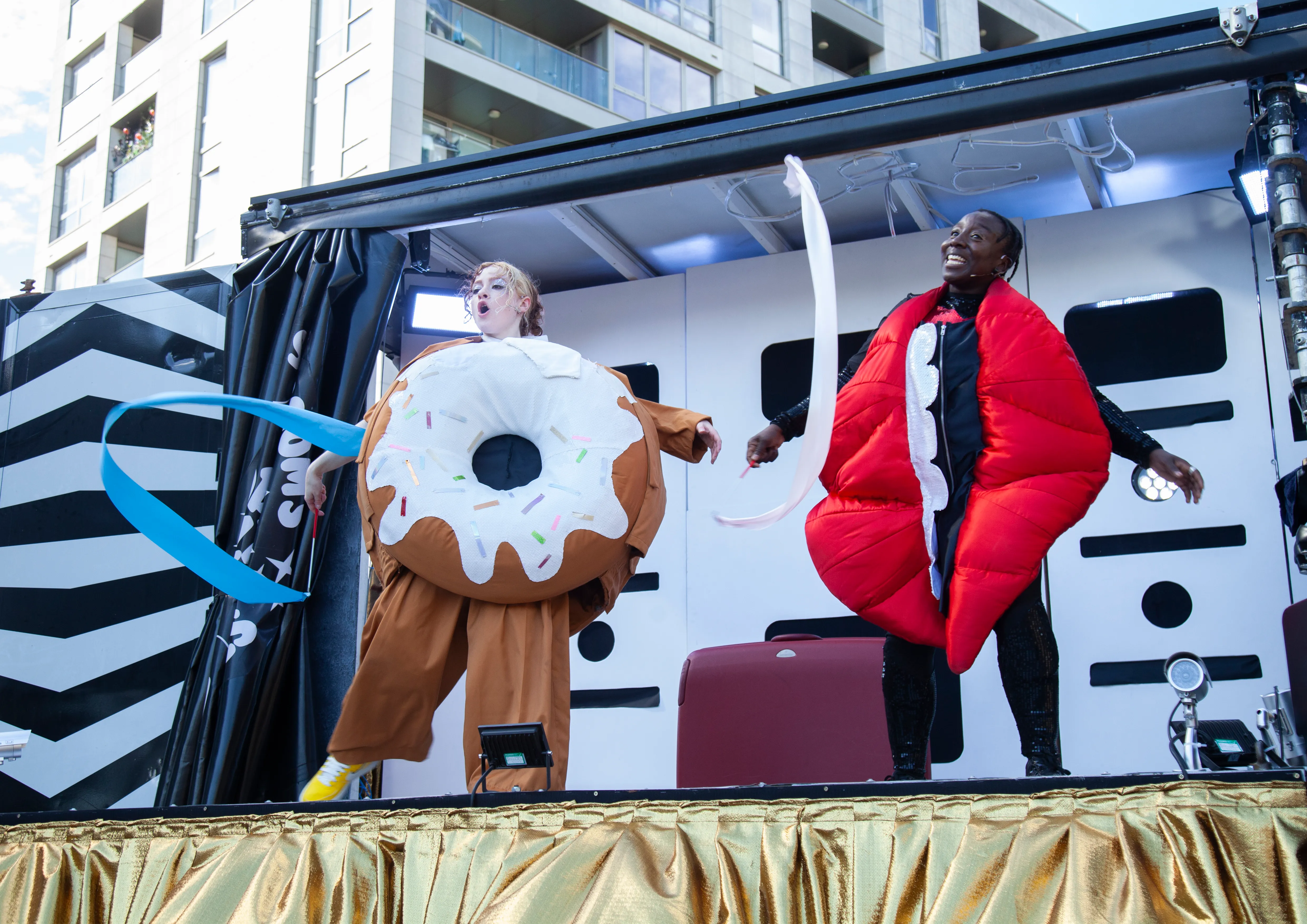 Doughnut and Mouth twirling ribbons on stage
