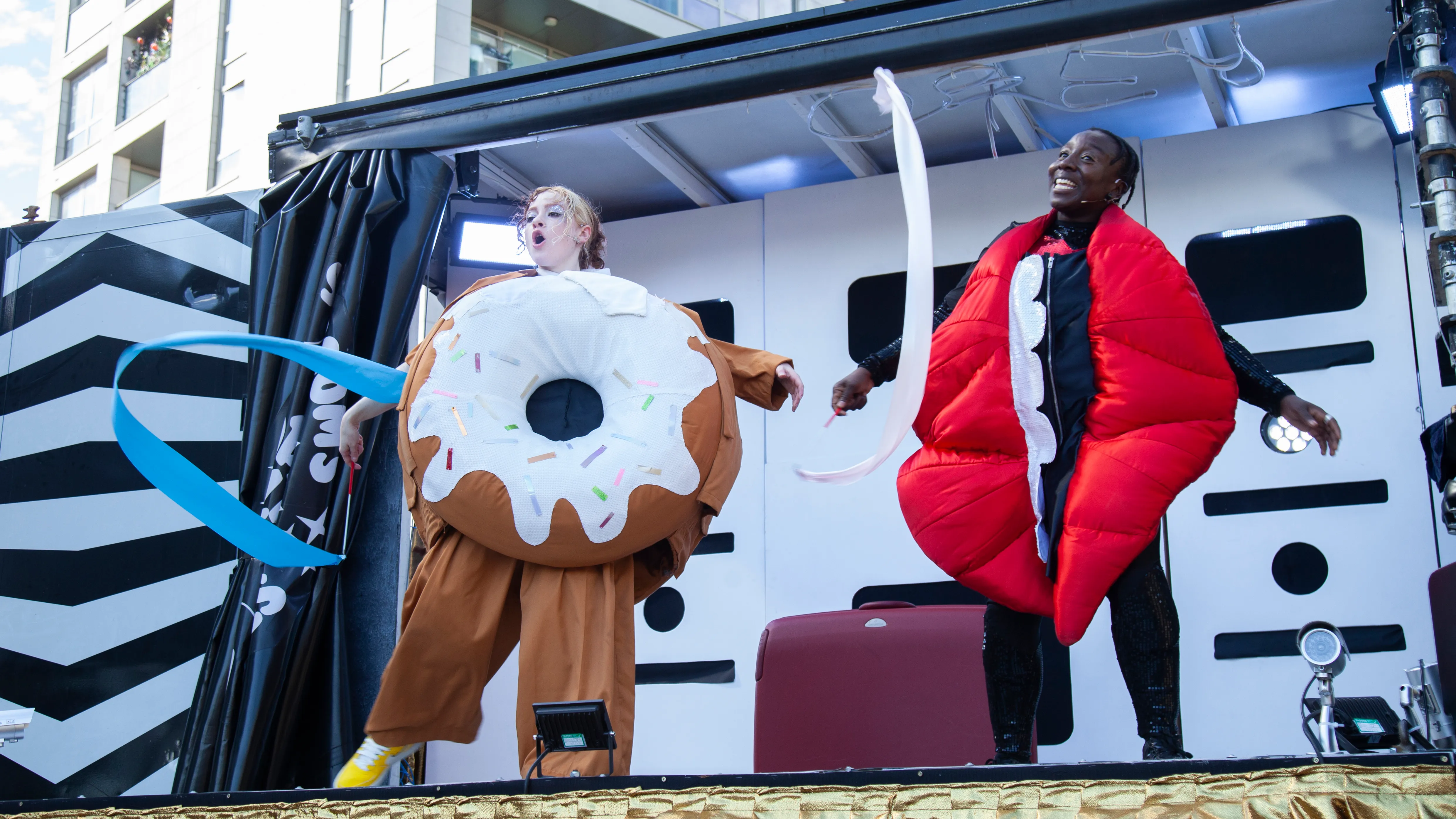 Doughnut and Mouth twirling ribbons on stage